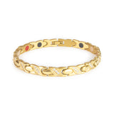 Glistening Star gold titanium bracelet, front view showing X-shaped links with sparkling crystal gems.