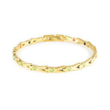 Vitalis gold-plated titanium bracelet with green crystals clasped front view.