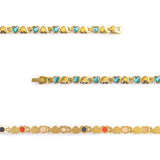 Close-up of Celeste bracelet showing gold-plated settings with blue crystal heart links.