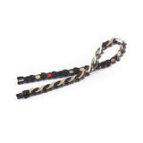 Ethereal negative ion bracelet folded unclasped to display black steel links and rose gold detail.