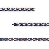 Close-up of white crystals and polished black links.