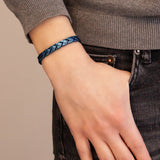 Close-up of female model with Majestic Blue bracelet on wrist, highlighting the geometric contrast between matte and polished blue finishes.