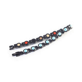 Obsidian Tide bracelet unclasped and folded to display black steel links with turquoise crystals.