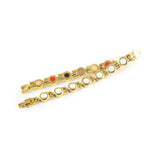 Opulent bracelet unclasped and folded to display gold links with white crystals.