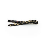 Perfect Balance bracelet unclasped and folded to display alternating black and gold links and refined craftsmanship.