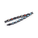 Polaris bracelet unclasped and folded to display black steel links with aqua crystals.