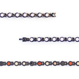 Close-up showing pink crystals and refined black interlocking links.