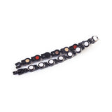 Bracelet folded and unclasped to display pink crystal accents and link design.