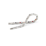 Serenity stainless steel bracelet unclasped and folded to display alternating polished and matte links with embedded elements.