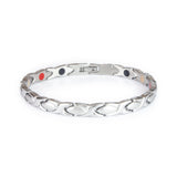 Serenity stainless steel bracelet front view showing polished X-shaped links alternating with matte almond-shaped spacers and single row of embedded elements.