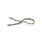 Vibrant Spark titanium bracelet unclasped and folded to display refined link pattern and crystal details.