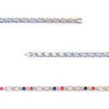 Close-up of Whisper bracelet showing light blue crystals and interlocking steel links.