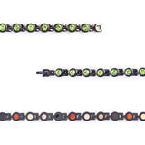 Close-up view showing green crystals and polished black interlocking links.
