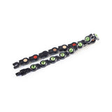 Bracelet laid flat and folded to display green crystals and link pattern.